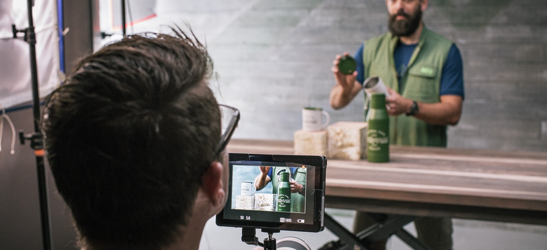 Person filming an REI employee demonstrating an REI product