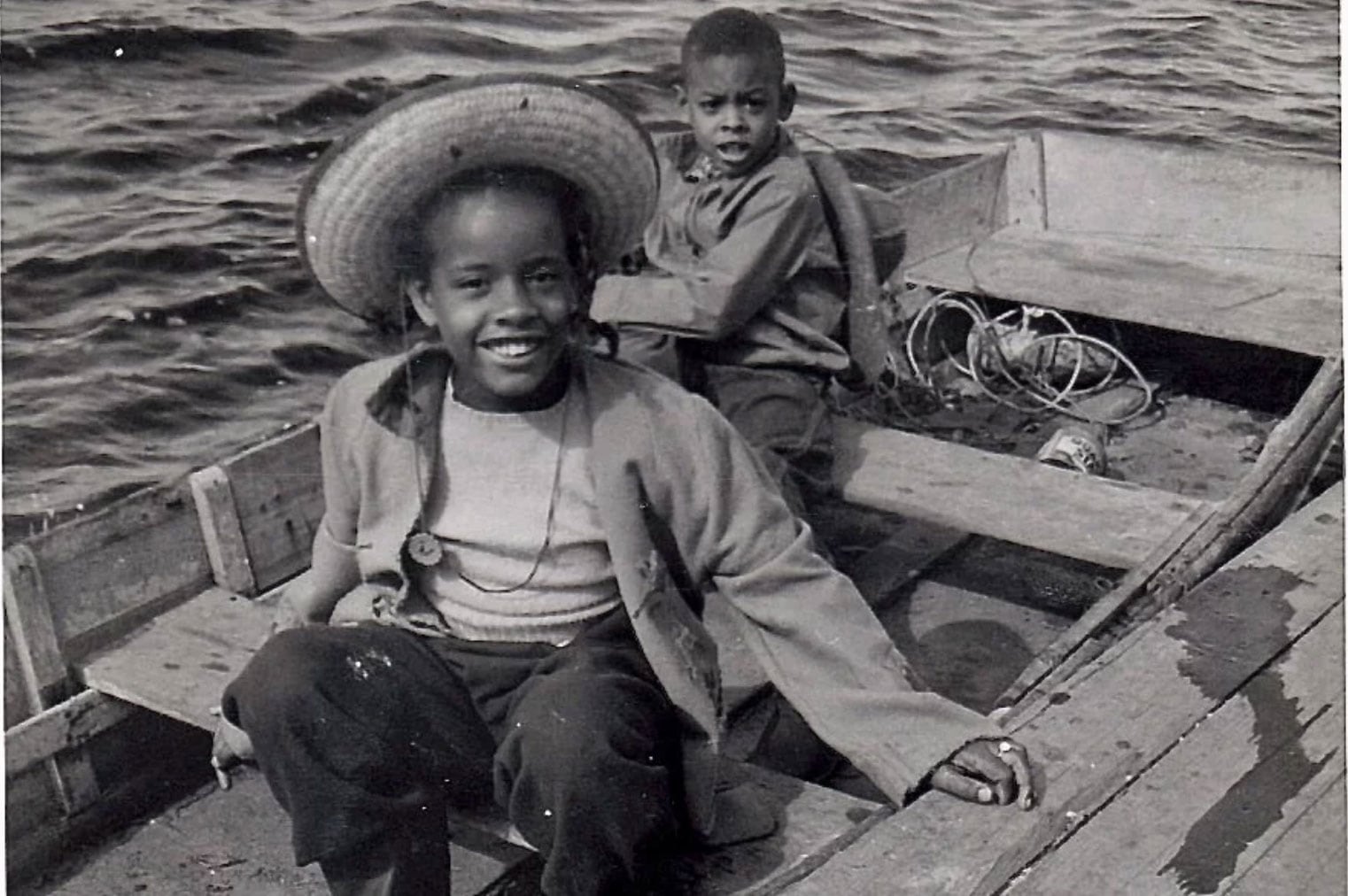 Two children in a wooden boat