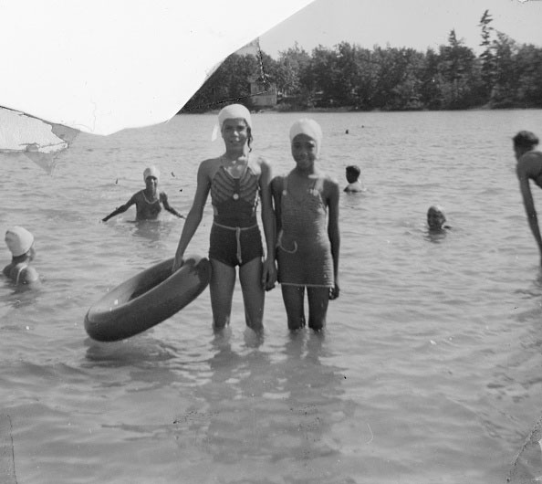 Two women standing in a lake