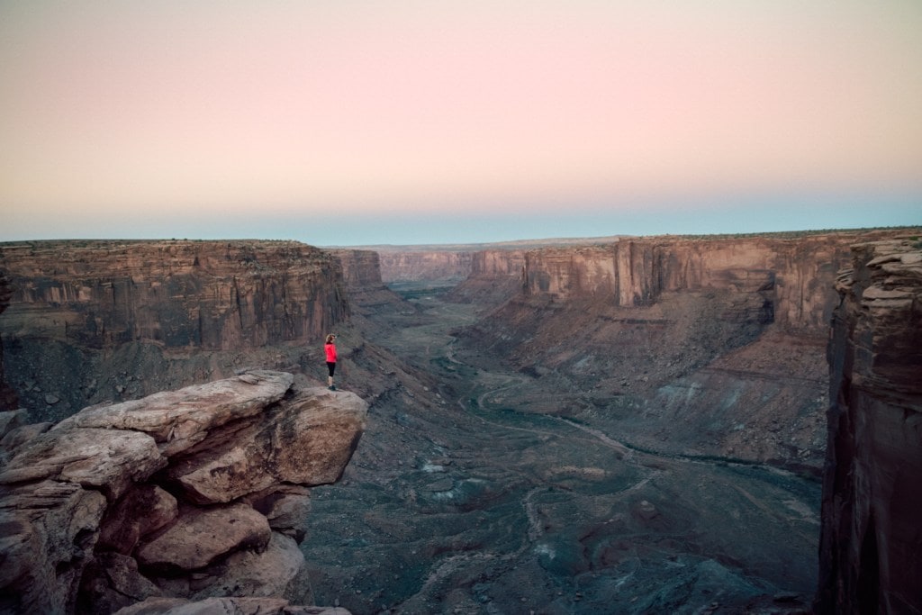 Clare Gallagher looking out over a desert canyon.