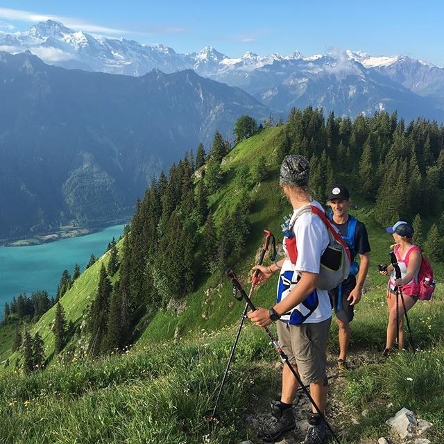 family hiking photos with green trails and snowy mountain views