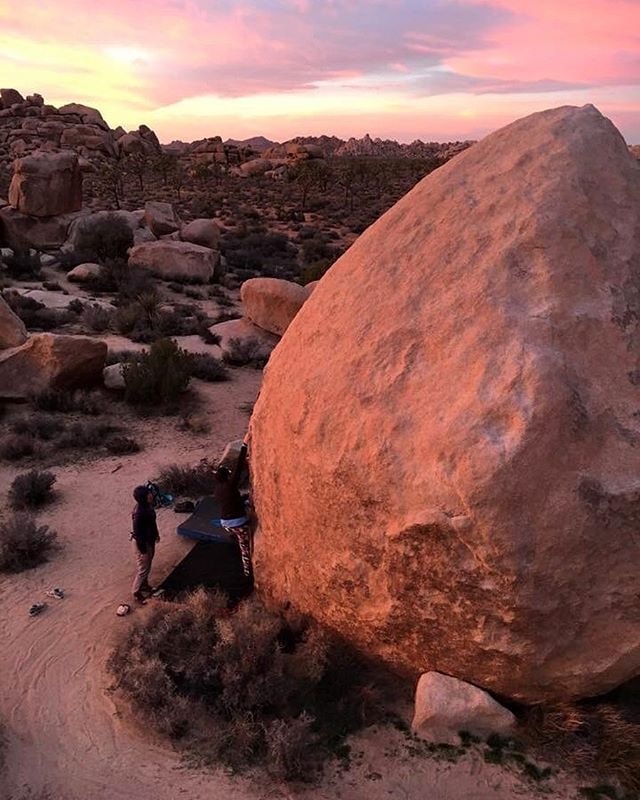 two people figuring out a bouldering project