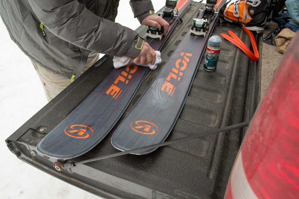 skier puts top wax to skis before heading out to the backcountry