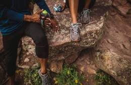 trail runners rest on a rock