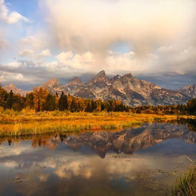 mountain reflected in lake at sunset