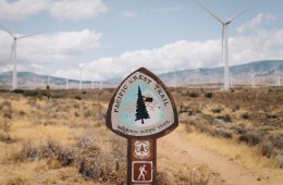 PCT trail sign with wind turbines in the background