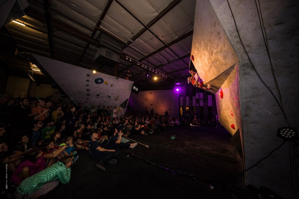 Brittany Goris bouldering in front of a crowd.