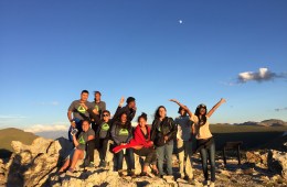 a group of outdoor stewards celebration on a mountain top