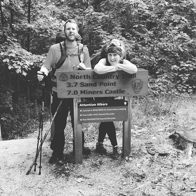 Two friends at hiking sign