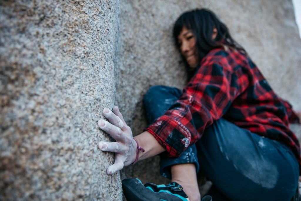 Shelma pushing climbing a boulder