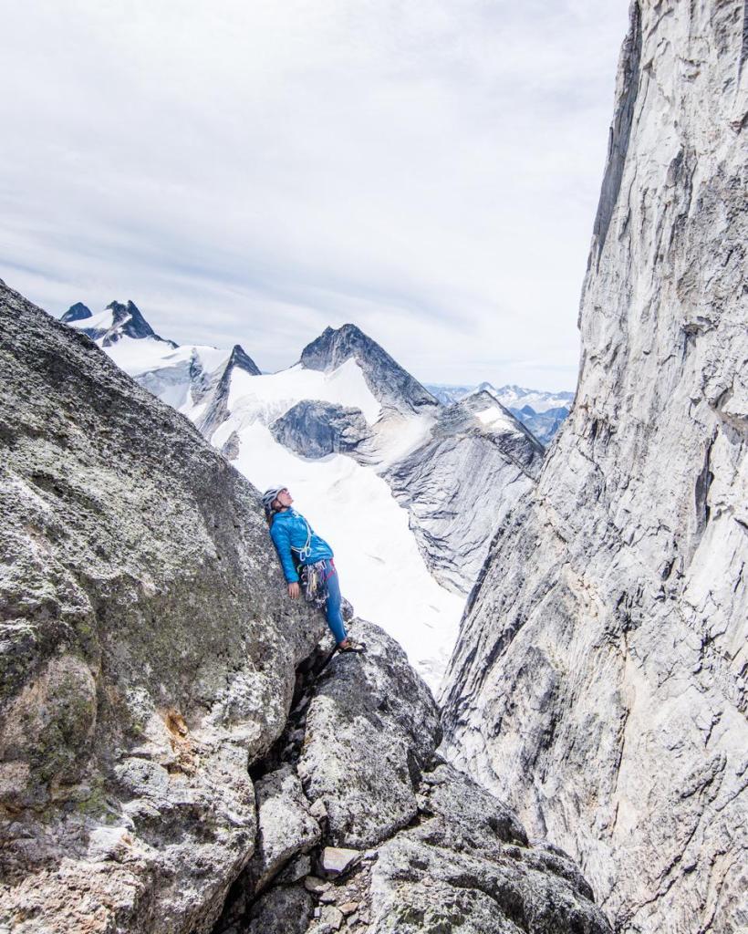 climber resting on a rock in the alpine