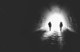 Two hikers in a tunnel