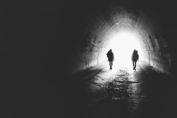 Two hikers in a tunnel