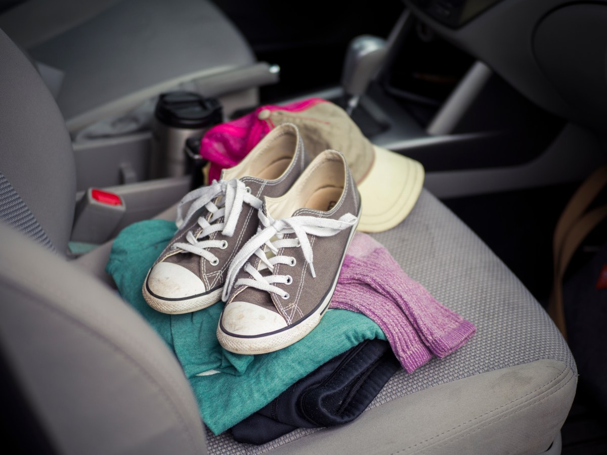 A set of clothes and a pair of shoes in a car