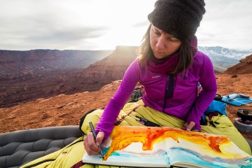 Sarah Uhl works on a watercolor painting in Castle Valley, Utah