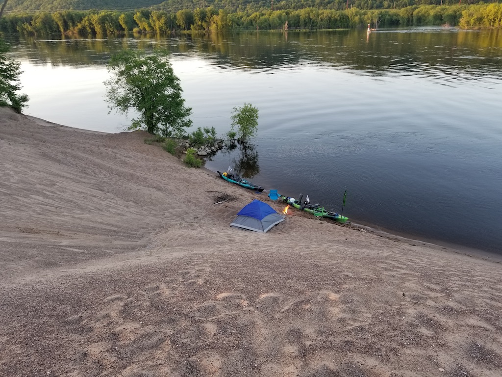 tent and boats on river