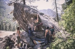 Climbers spotting each other while bouldering