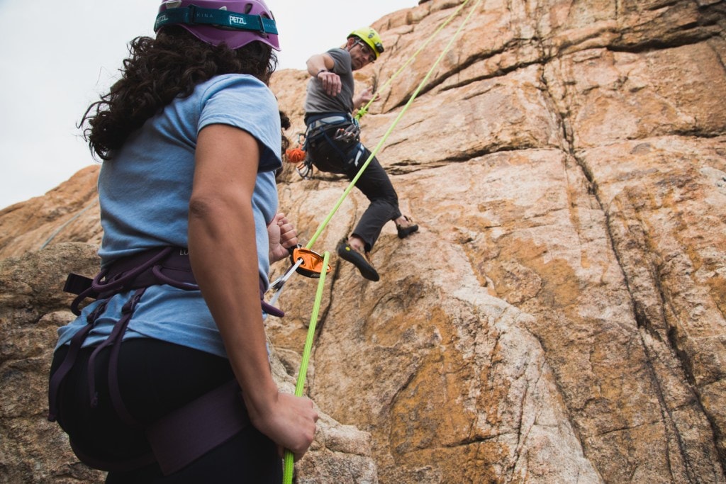 A climber lowering another climber.