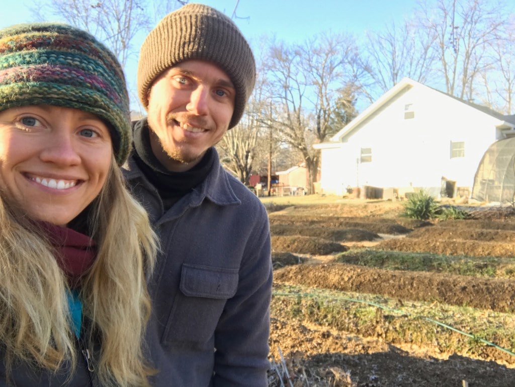 Smiling couple in front of a field.