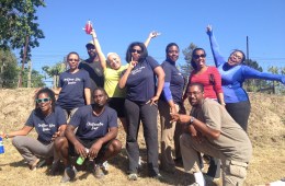 Rue Mapp, founder of Outdoor Afro, standing outside with a group of youth.