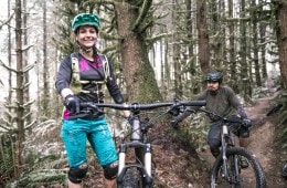 Two mountain bike riders standing by their bikes