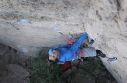 Adaptive climber Craig DeMartino pauses partway up an overhanging route to look for his next holds.