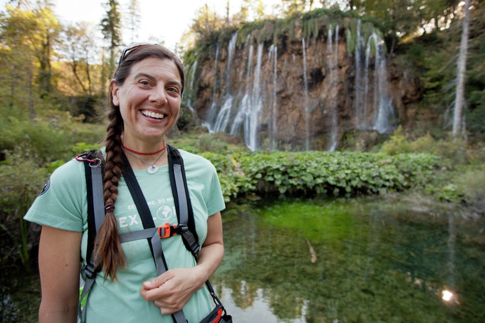 A traveler takes in the waterfalls of Plitvice Lakes National Park.