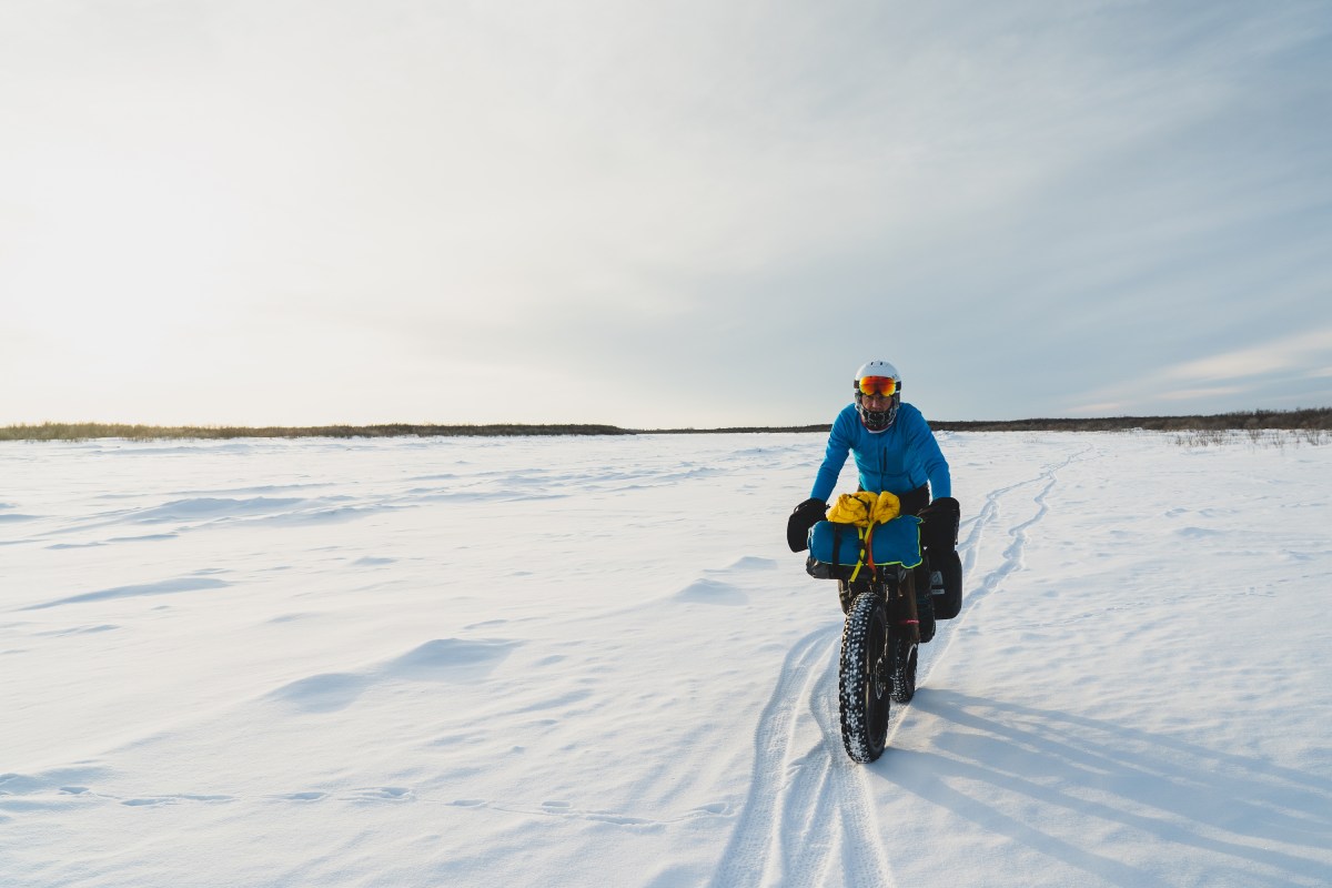 A man on a fat bike in a snowy field. 