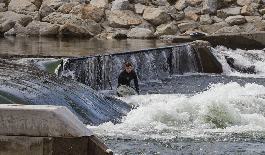 A surfer gets ready to catch a wave at Boise's free whitewater park.