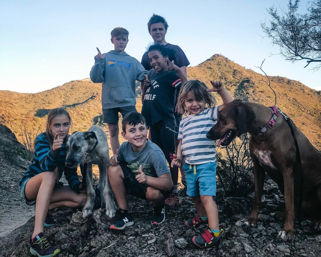 The Redden family of six kids and their dog head out for a hike together. 