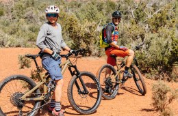 Two mountain bikers pause to take in the view surrounded by a desert landscape