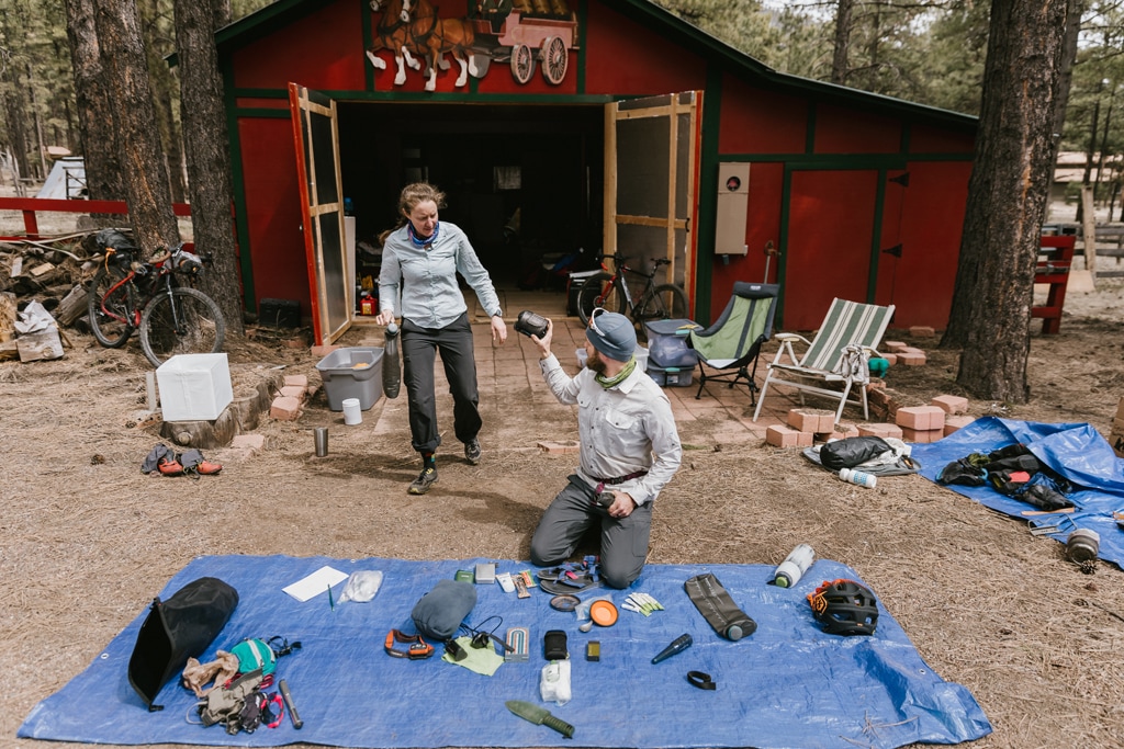 Amanda and Devon pack for a bikepacking trip outside their barn.