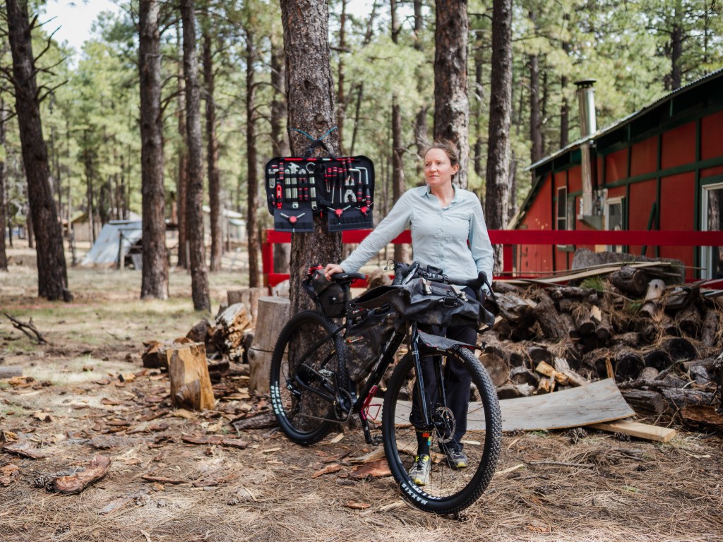 Amanda stands outside the barn with her bike.