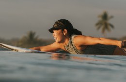 Bonnie Tsui smiling and paddling through water.