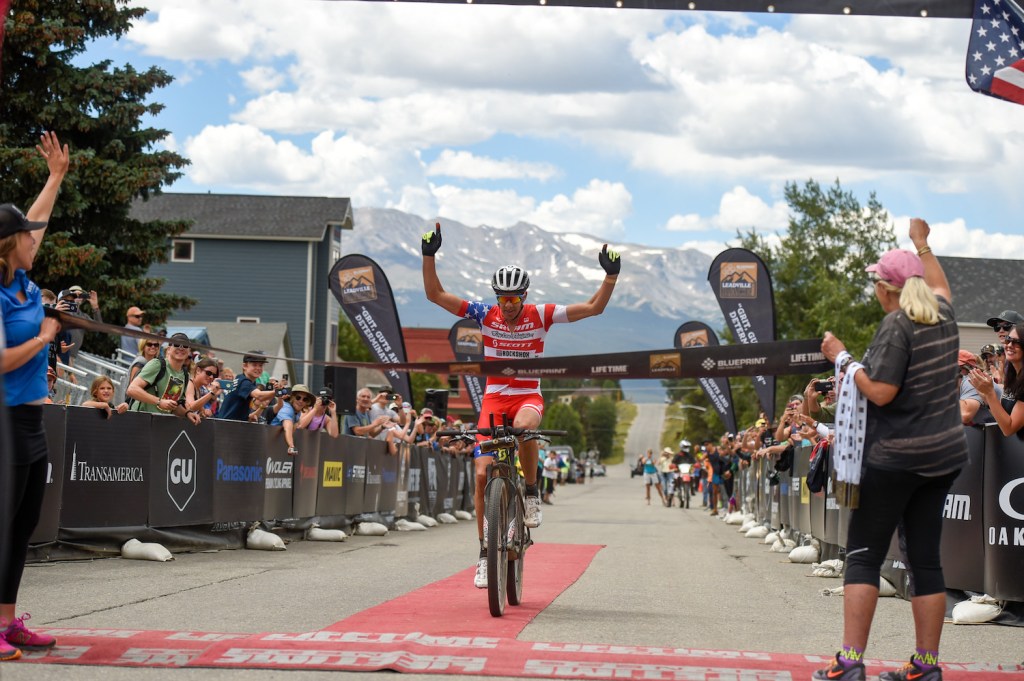 Mountain biker Todd Wells crosses the finish line in first.