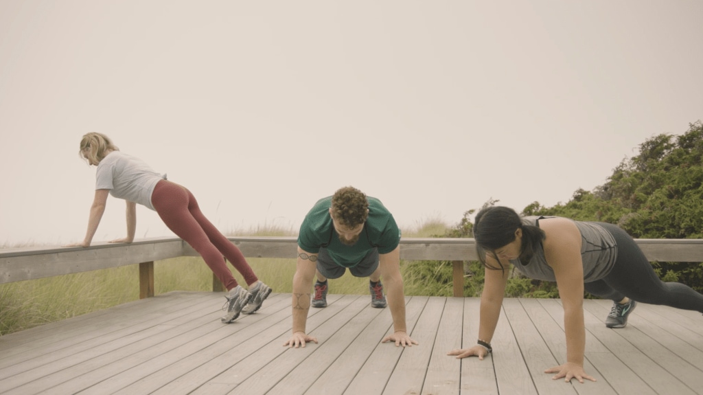 Corepower yoga instructors hold plank pose