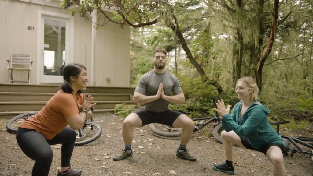 Corepower yoga instructors do wide-legged squats