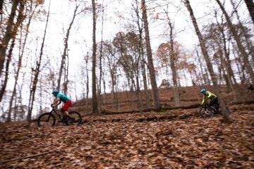 Two mountain bikers ride a trail in Athens, Ohio