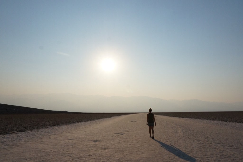 A hiker walks across Badwater Basin.