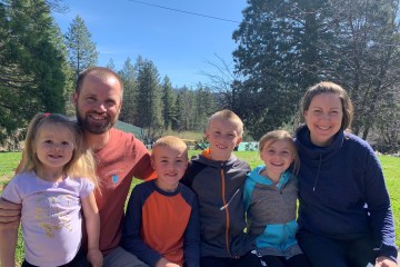 The Gist family poses as a family outside.