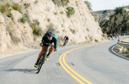 Amber Pierce riding her bike on a road.