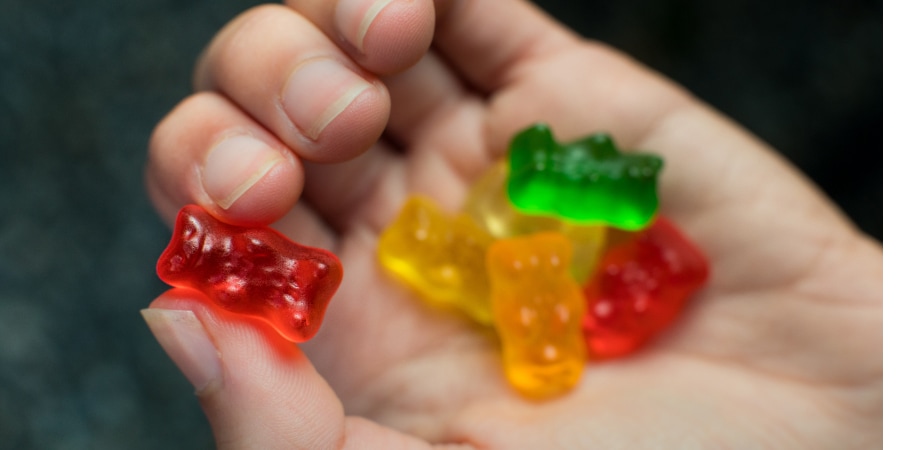 A hand holding gummy bears. 