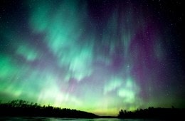 The green and purple glow of the Northern Lights over the Boundary Waters in northern Minnesota