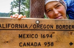 Thru hiker Jasmine Star stops at a trail marker on the PCT.