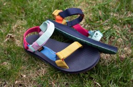 The author's rainbow Teva sandals are laying on the grass