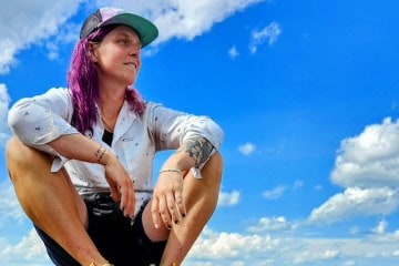 A portrait of Lyla Harrod in front of a blue sky.