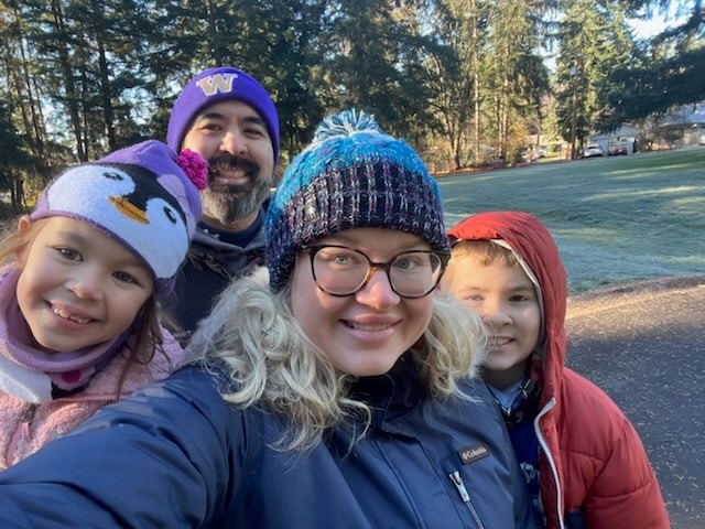 Photo of a woman with her husband and two small children for their #OptOutside tradition of picking up litter 