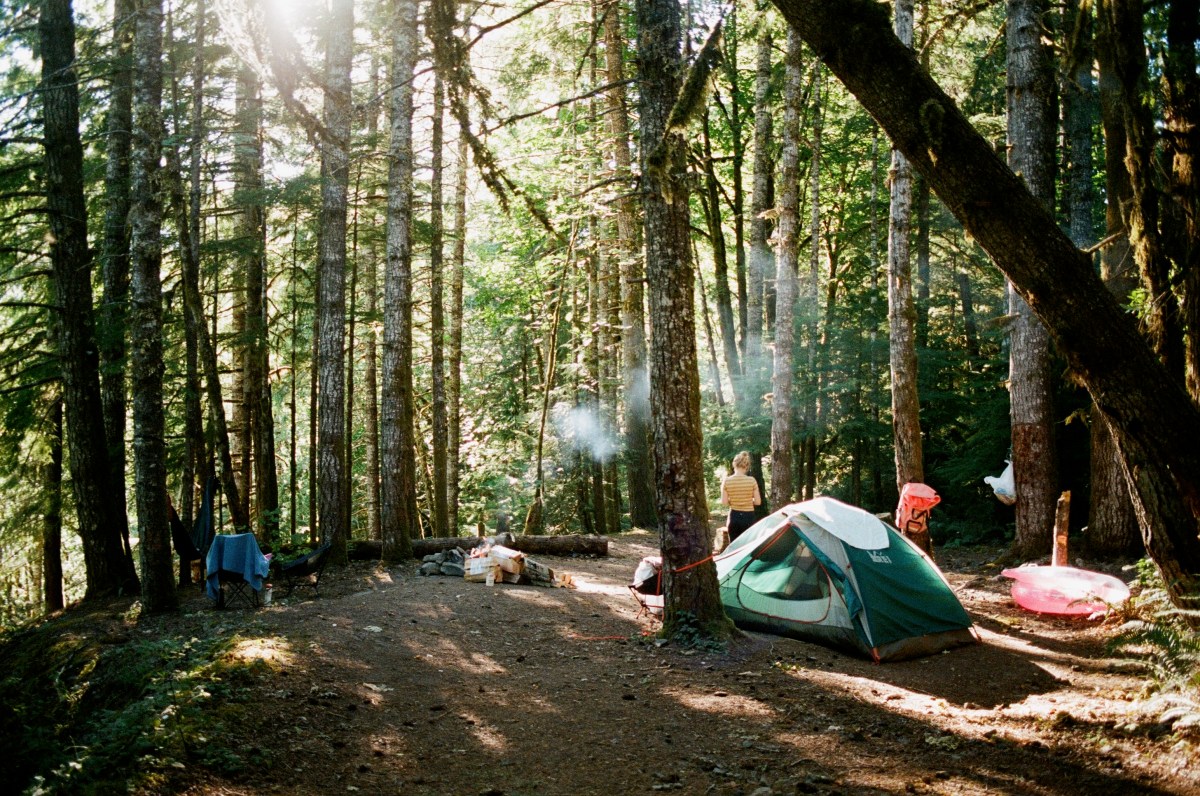 Photo of a campsite. There is a green Half Dome Tent in the photo.