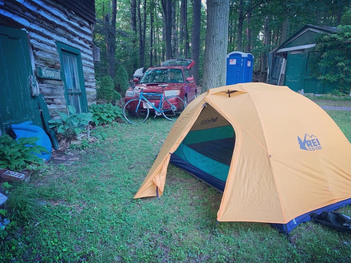 Photo of an REI Co-op Half Dome Tent outside a cabin.