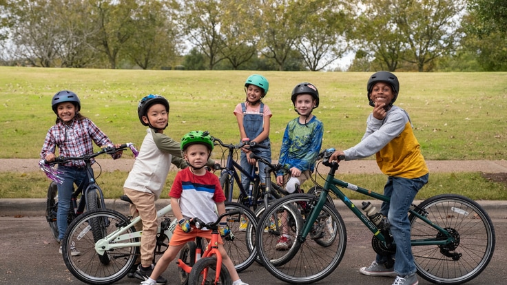 Group of kids on their bikes posing for the camera